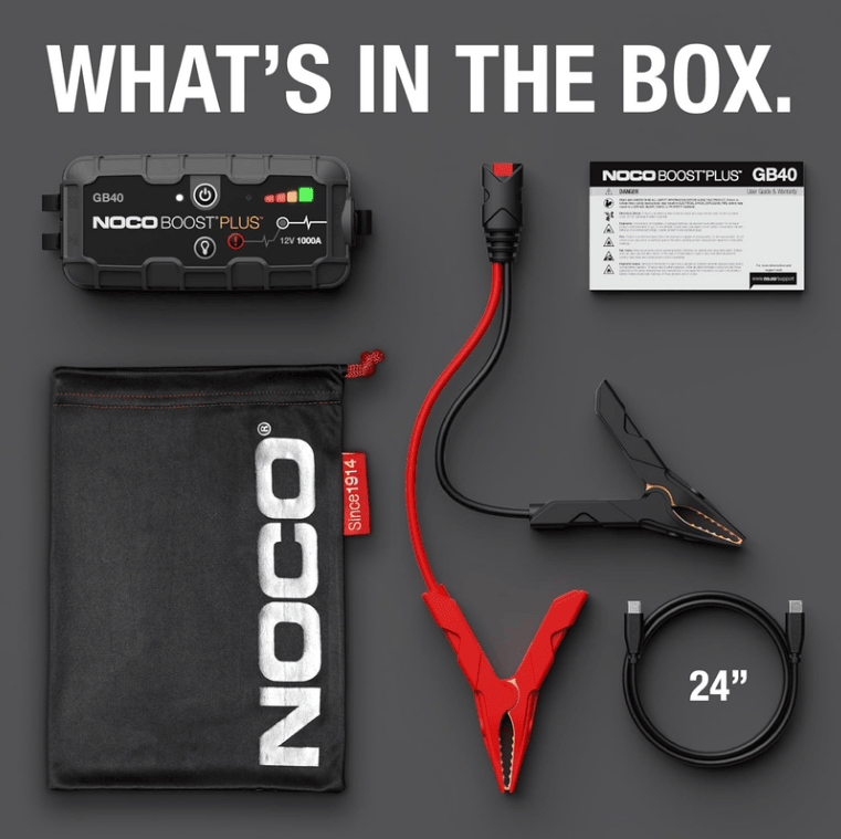 NOCO Boost GB40 1000A jump starter box contents with battery clamps, charging cables, storage bag and user guide